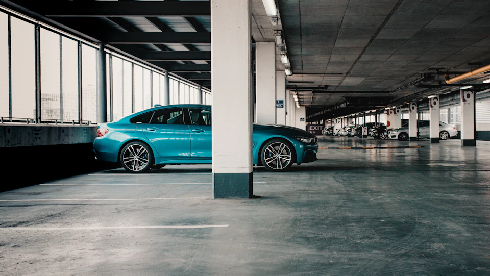 Blue sedan parked in a covered garage